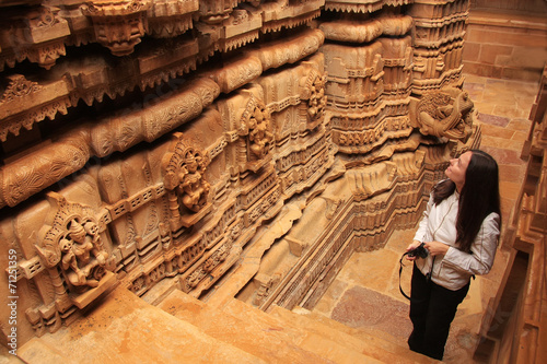 Young woman admiring interior of Jain temple, Jaisalmer, Rajasth photo