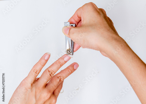 woman cutting fingernail.