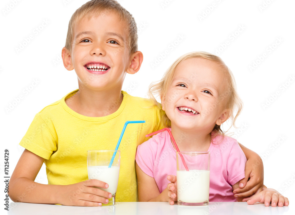 Cute little girl and boy are drinking milk