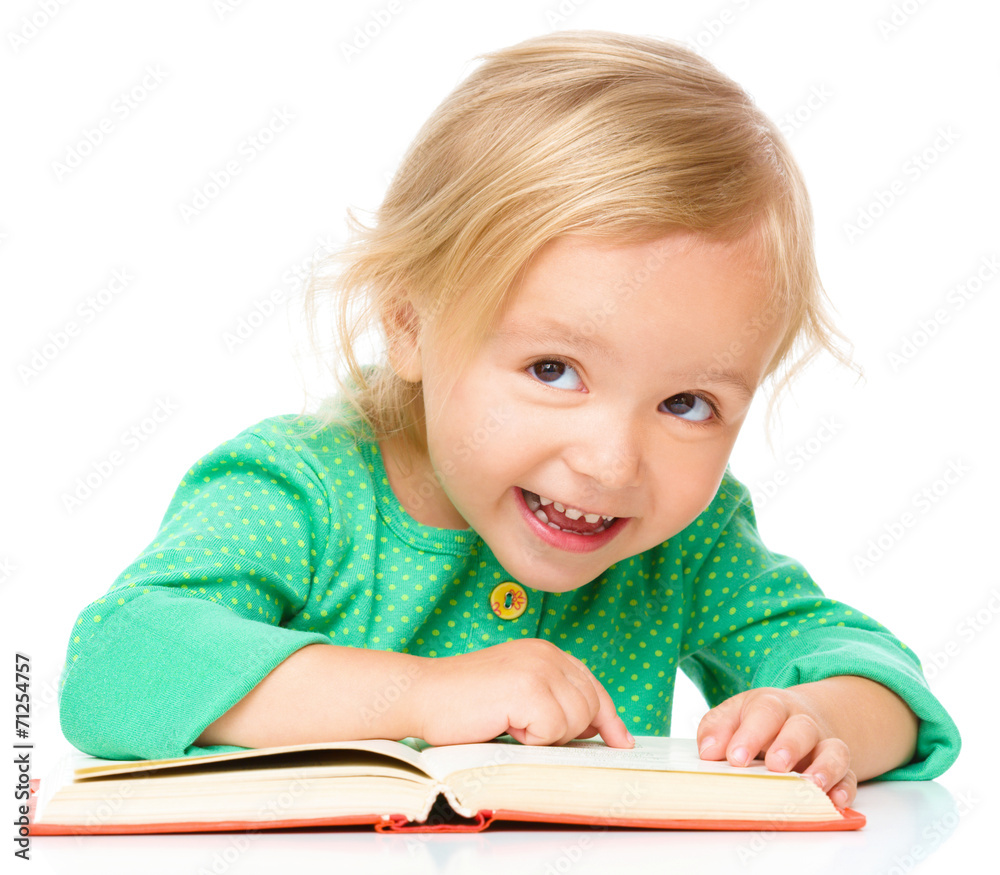 Little girl is reading her book Little girl is reading her book