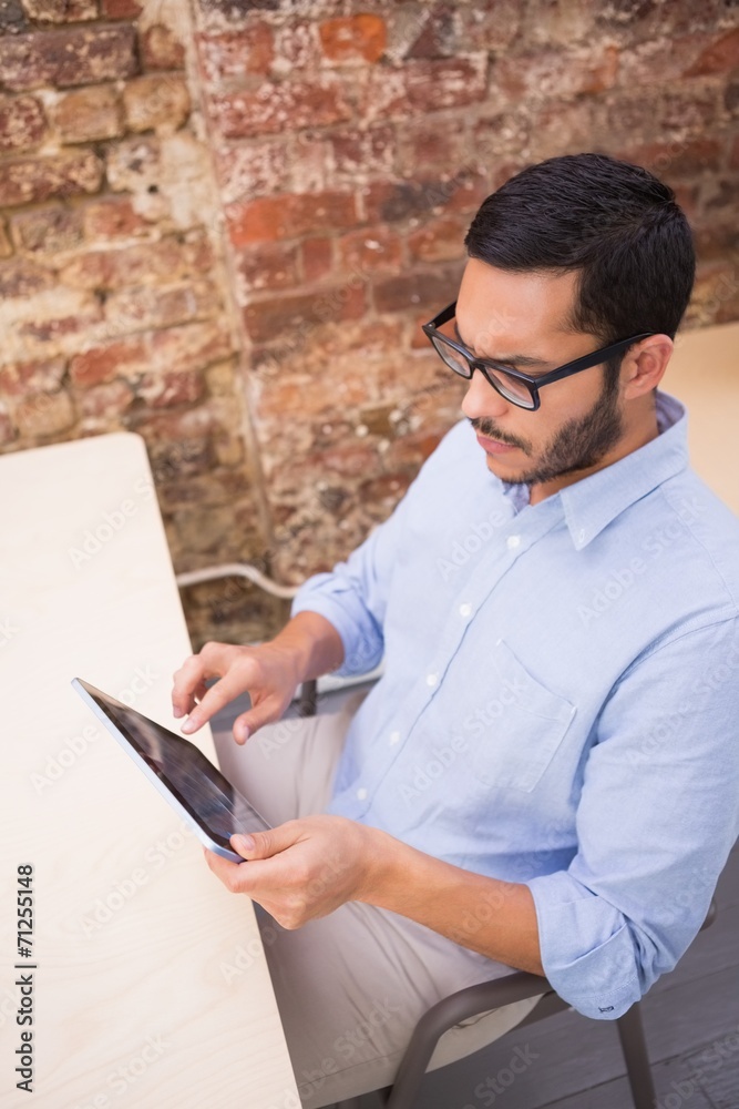 Businessman using digital tablet at desk Businessman using digital tablet at desk