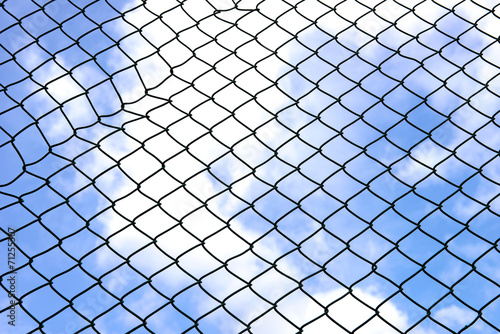 Silhouette wired fence with blur cloud and blue sky background