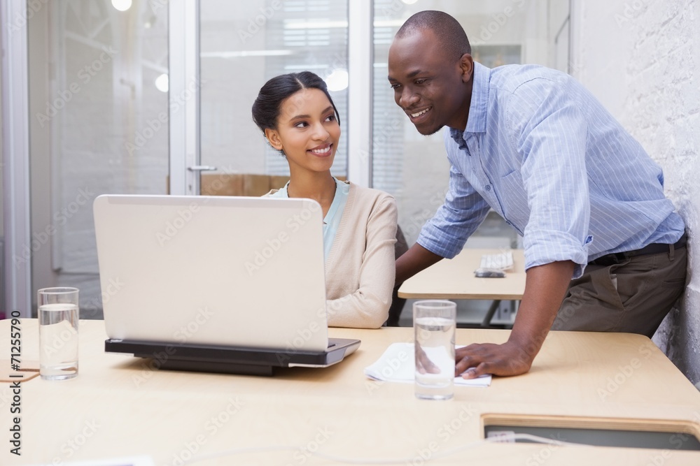 Business team working happily together on laptop Business team working happily together on laptop