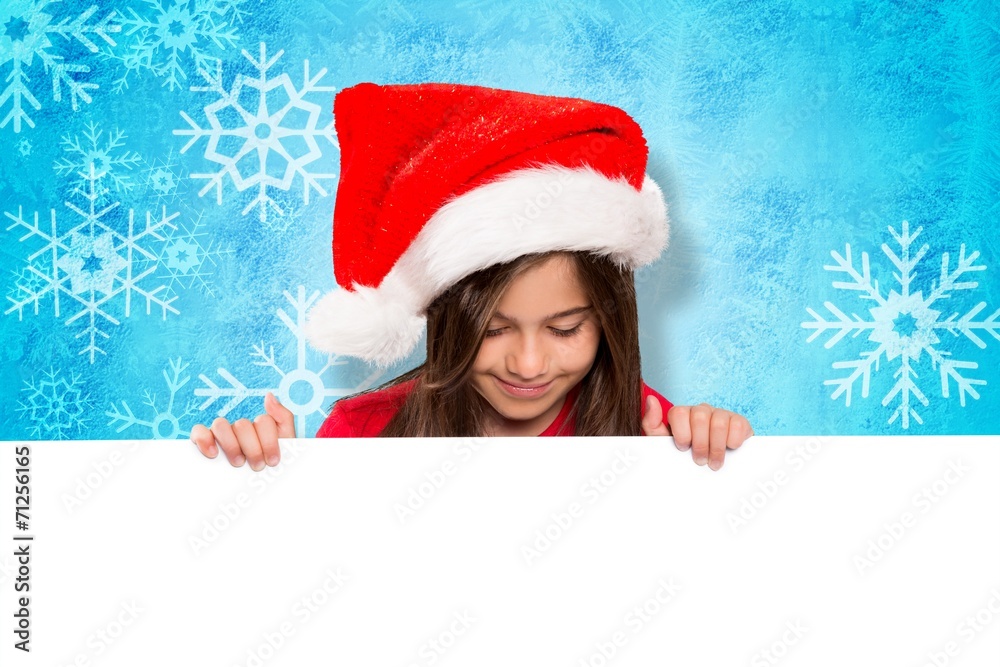 Composite image of festive little girl showing card Composite image of festive little girl showing card