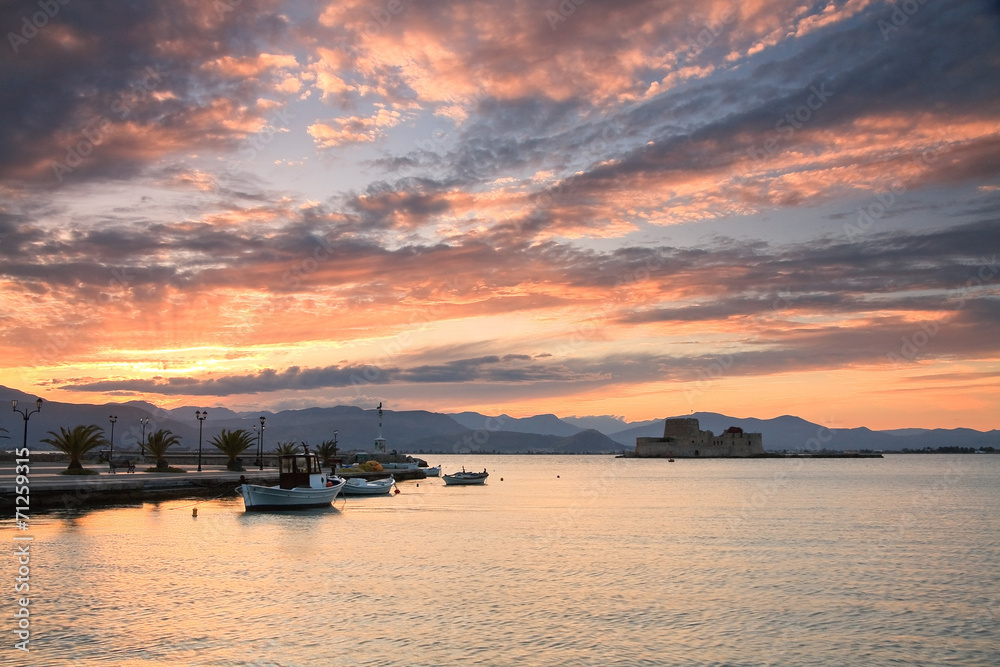Sunset in the fishing harbour in Nafplio, Greece.