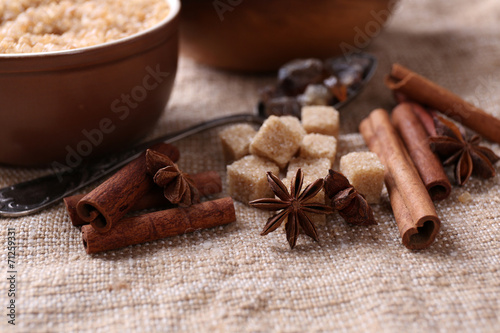 Brown sugar cubes and crystal sugar, spices in bowl