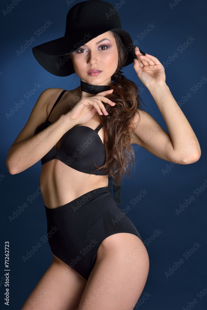 Beautiful woman in a black lingerie and big hat. Beautiful woman in a black lingerie and big hat.