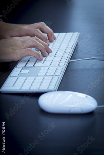 Businesswoman typing at computer