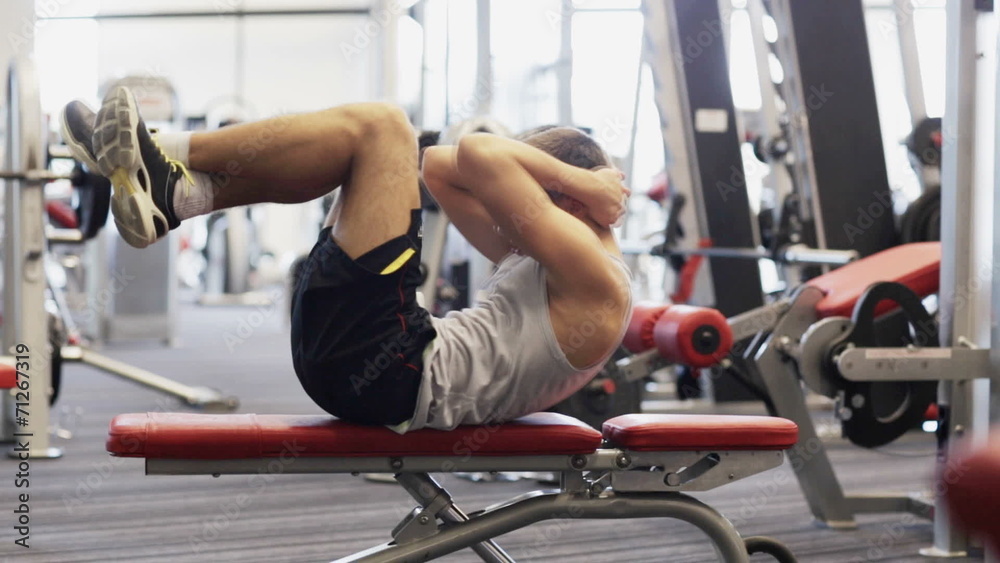 young man with dumbbell in gym