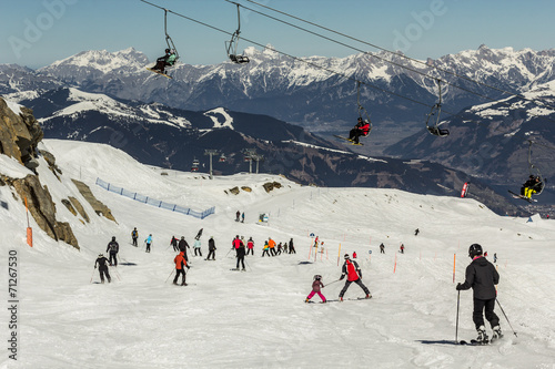 Skiing people and the chair lifts of ski region in Austria 