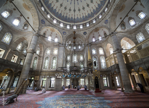 People perform the ritual prayers of islam in Eyup Sultan Mosque photo
