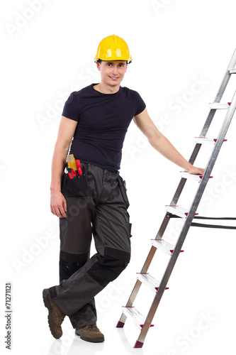Manual worker posing with a ladder.