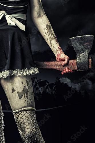 evil woman holding a bloody ax