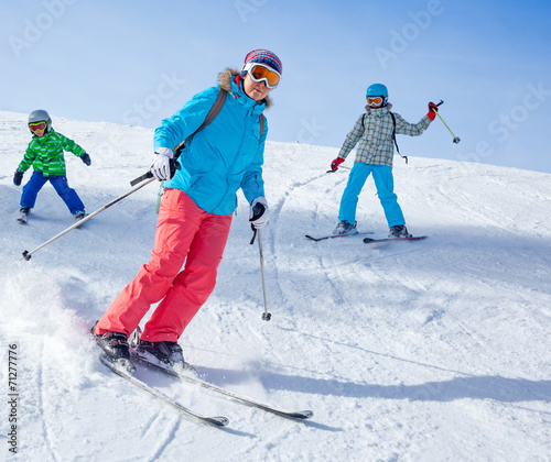 Two kids with mother enjoying winter vacations.
