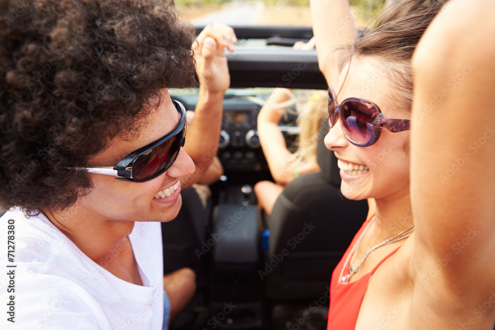 Group Of Young Friends Dancing In Back Of Open Top Car Group Of Young Friends Dancing In Back Of Open Top Car