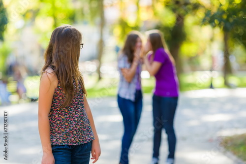 Girl looking back at her evil girlfriends