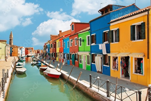 colorful houses by the water canal at the island Burano Venice
