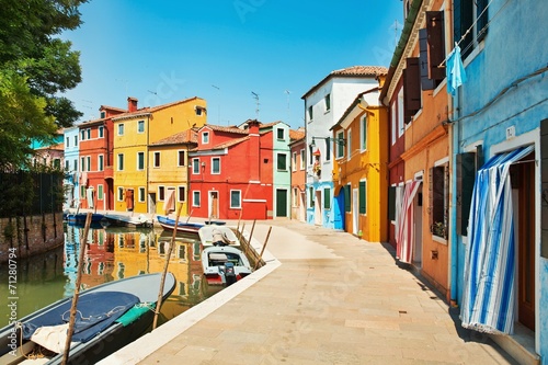colorful houses by the water canal at the island Burano Venice