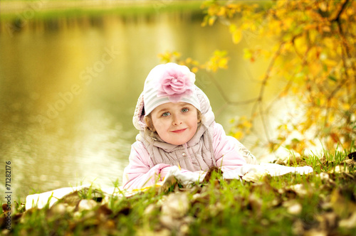 girl lying on the grass in the autumn park