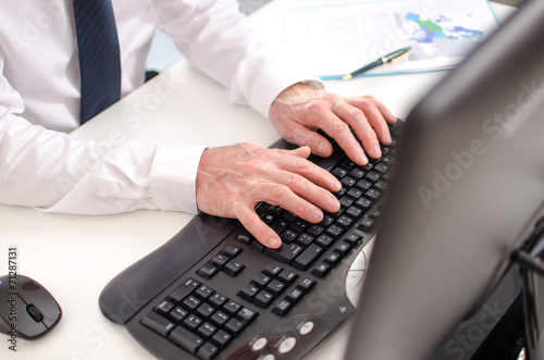 Hands typing on a keyboard