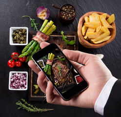 Hand taking photo of prepared food with smartphone