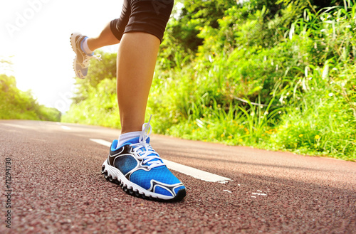 fitness woman runner legs running on trail