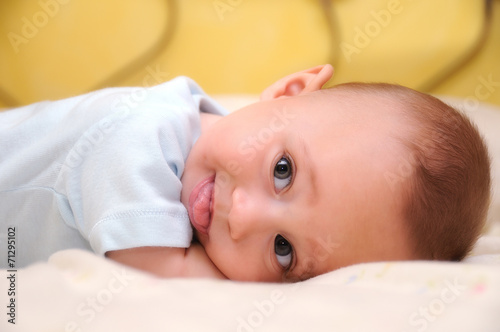 funny baby mocking on bed