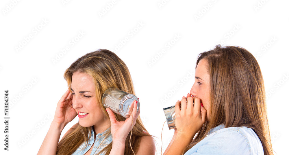 Friends talking by tin over white background Friends talking by tin over white background