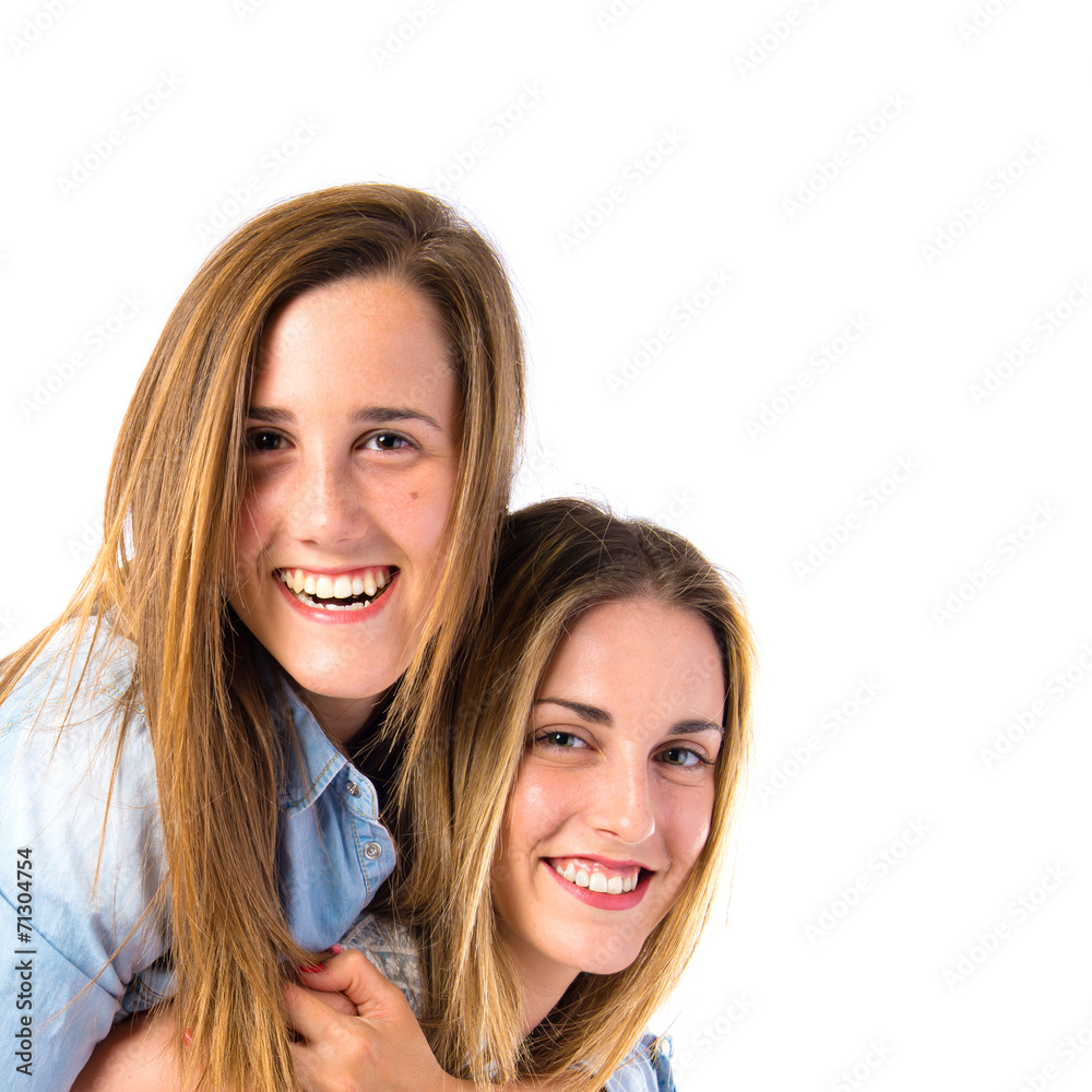 Sisters playing over white background Sisters playing over white background