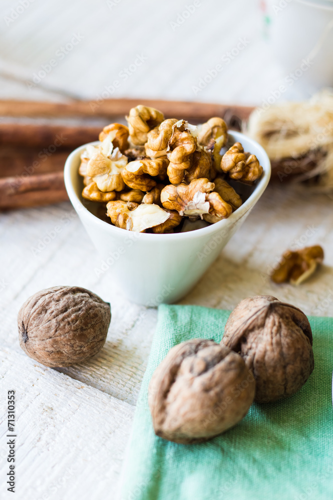 raw walnuts in a white bowl, white background raw walnuts in a white bowl, white background
