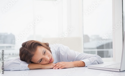 Tired businesswoman resting at her desk