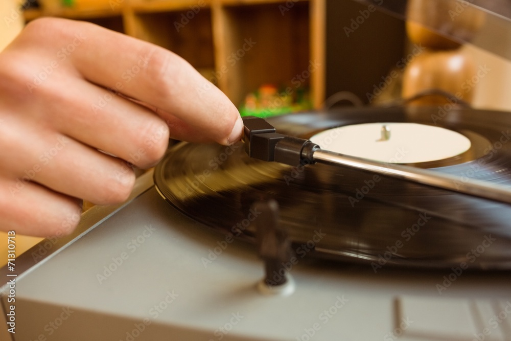 Young man putting on a vinyl Young man putting on a vinyl
