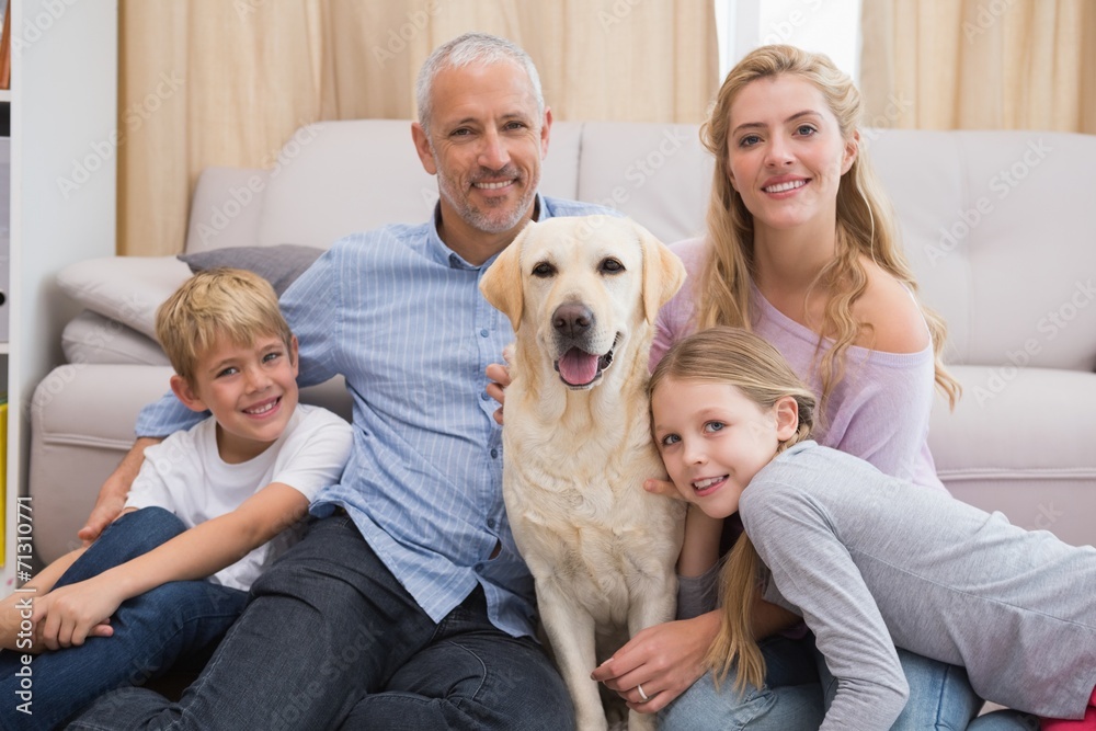 Parents and children on rug with labrador Parents and children on rug with labrador