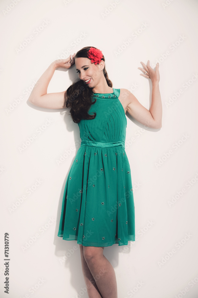 Retro fifties brunette fashion woman wearing red flower and gree Retro fifties brunette fashion woman wearing red flower and gree