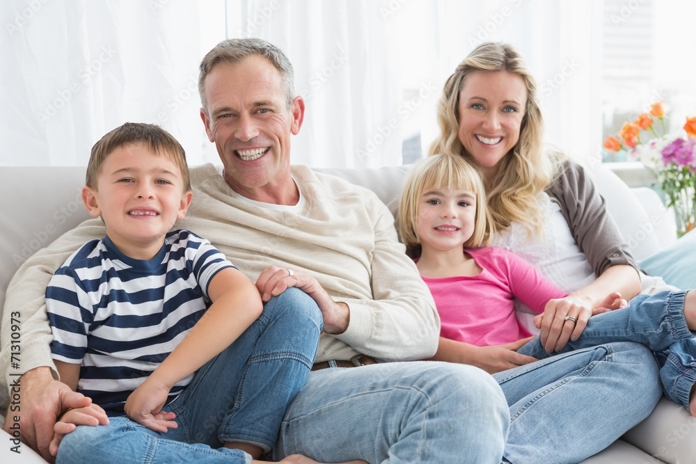 Portrait of a smiling family sitting on sofa