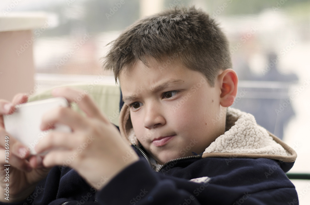 Boy kid child playing with mobile phone Boy kid child playing with mobile phone