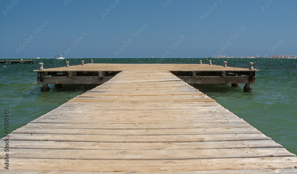 A wooden jetty, stretching out into the Mediterranean sea