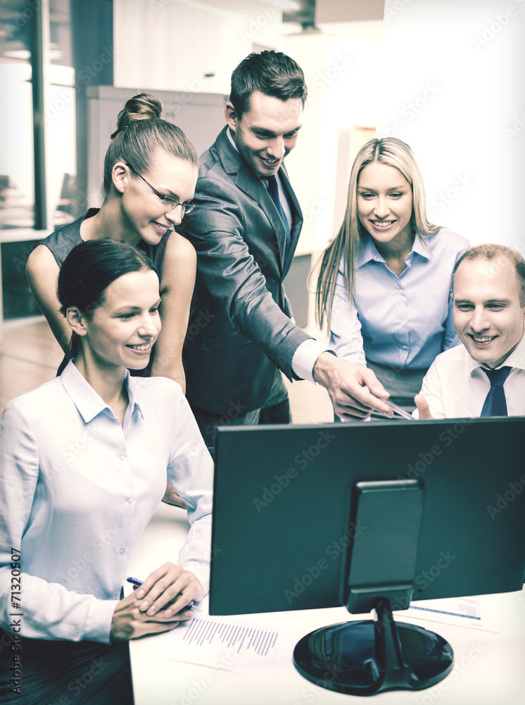 business team with monitor having discussion