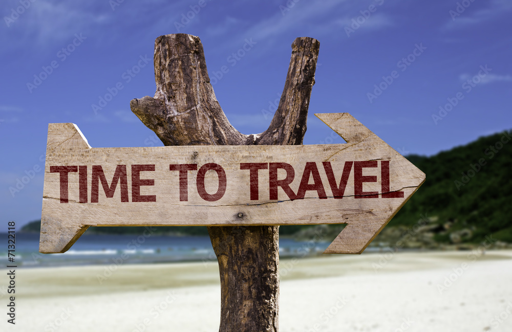 Time to Travel wooden sign with a beach on background