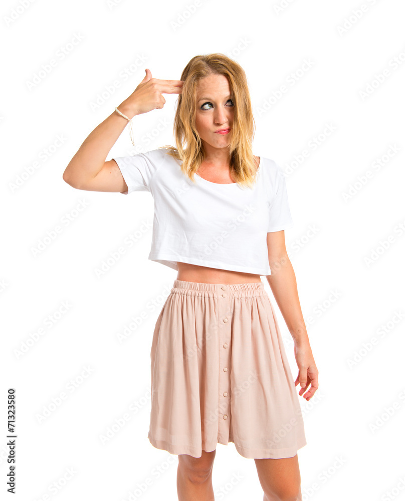 Girl making suicide gesture over white background Girl making suicide gesture over white background