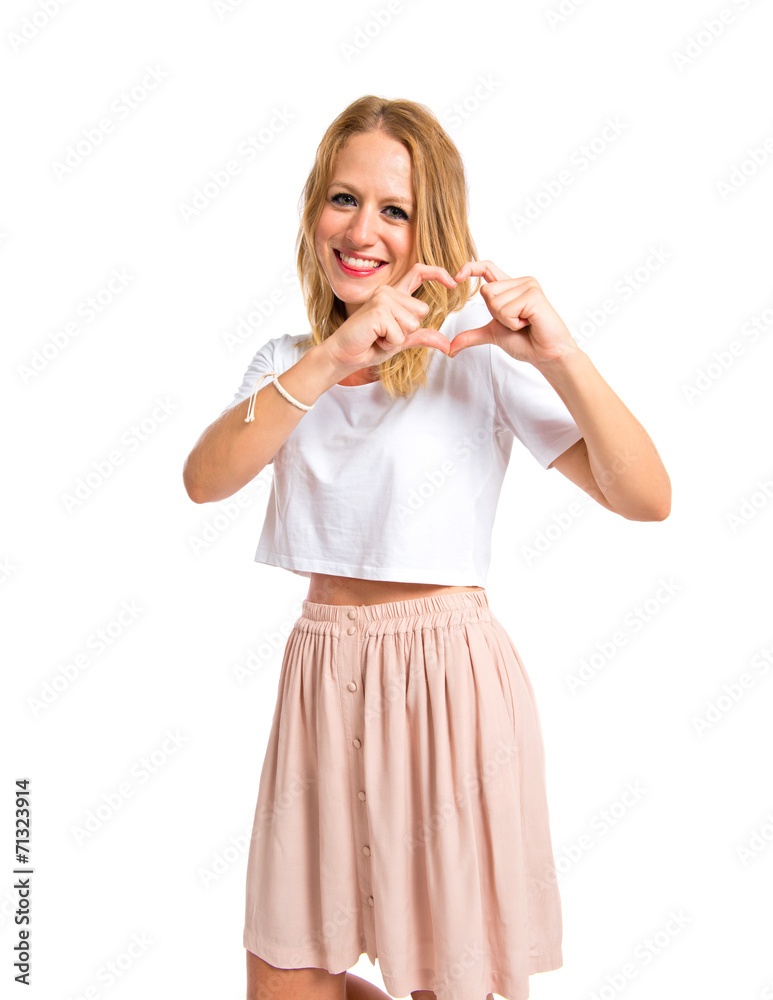 Girl making a heart with her hands over white background Girl making a heart with her hands over white background