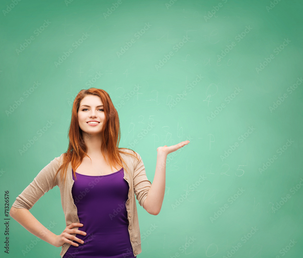 smiling teenage girl holding something on her palm