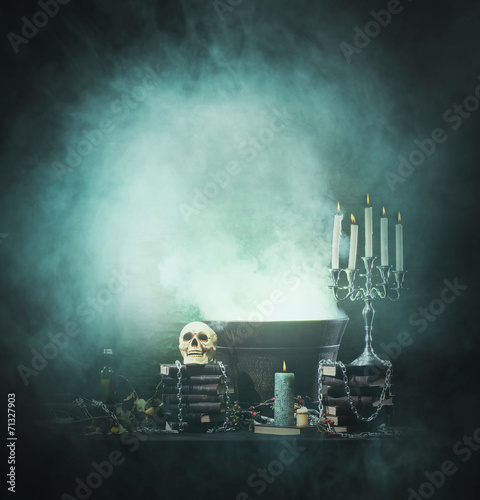 Halloween background with witchcraft tools: a scull, candles photo