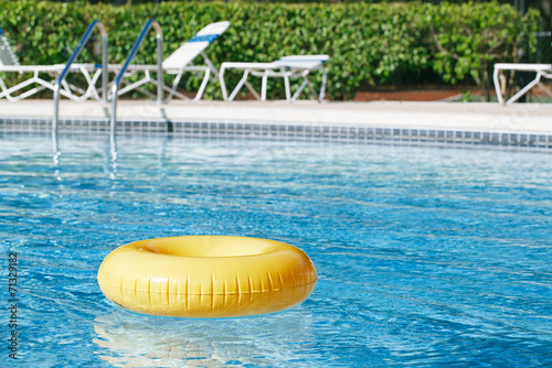 floating ring on blue water swimpool with waves reflecting