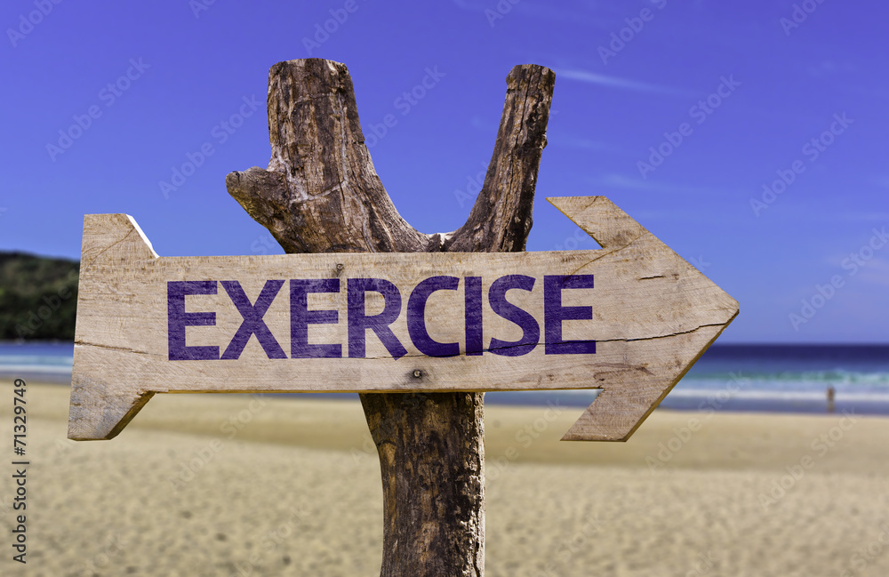 Exercise wooden sign with a beach on background