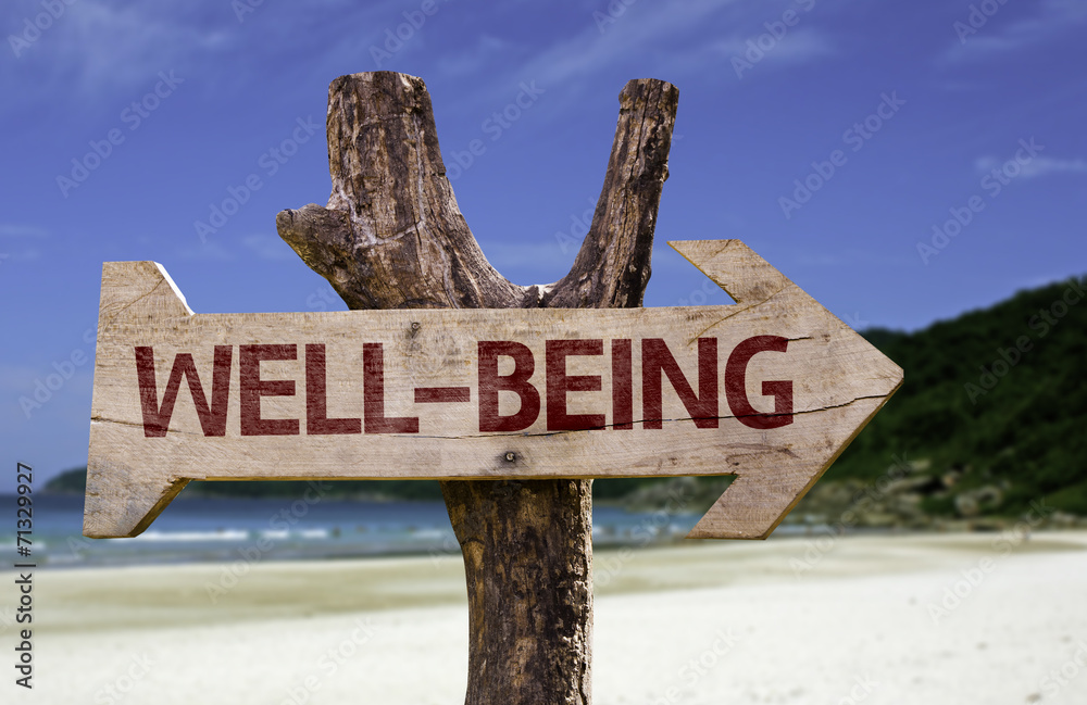 Well-Being wooden sign with a beach on background - obrazy, fototapety, plakaty 