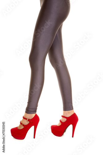 woman legs silver pants red heels stand side