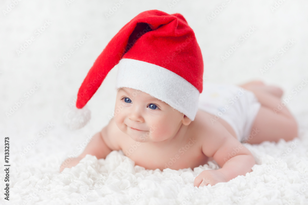 Baby lying in a Christmas cap Baby lying in a Christmas cap