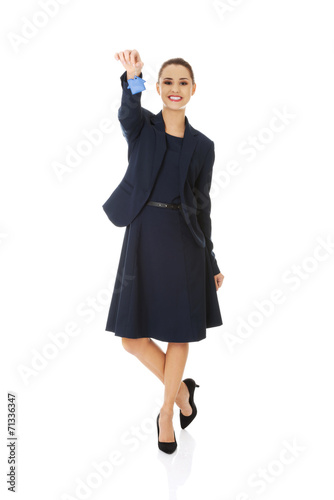 Happy real estate agent, holding a house key