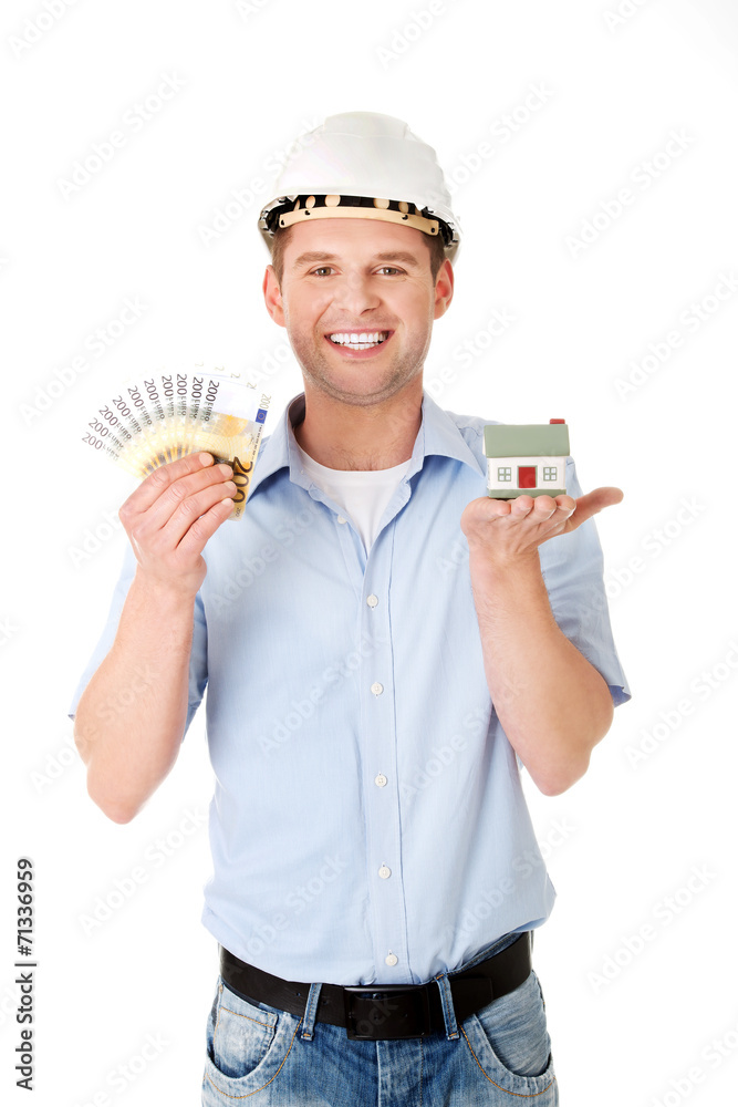 Construction man holding house model and money Construction man holding house model and money